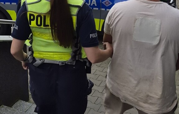 policjantka prowadzi zatrzymanego mężczyzne